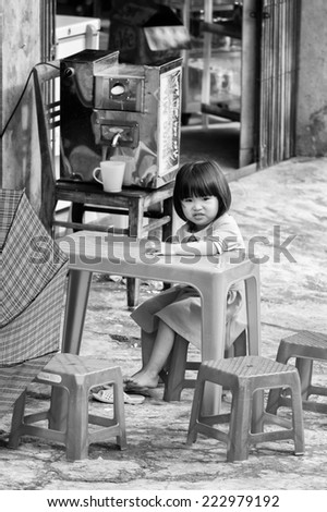 CATCAT VILLAGE, VIETMAN - SEP 12, 2014: Unidentified Vietnamese girl sits at the table in the Catcat village, Vietnam. 86% of Vietnamese people belong to the Viet ethnic group