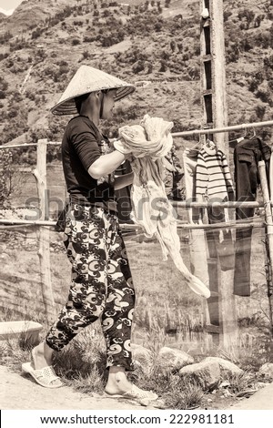 LAO CHAI, VIETMAN - SEP 12, 2014: Unidentified Black Hmong woman works in Lao Chai, Vietnam. Hmong is a ethnic minority group in Vietnam