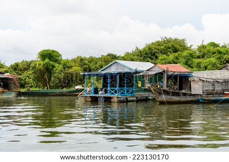 LAKE TONLE SAP, COMBODIA - SEP 28, 2014: Boats and houses of the Chong Knies Village on the Tonle Sap Lake, the largest freshwater lake in Southeast Asia, a UNESCO biosphere since 1997
