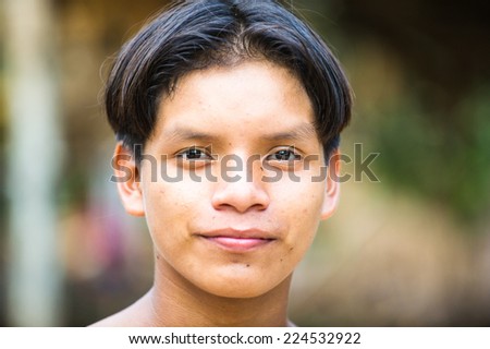 AMAZONIA, PERU - NOV 10, 2010: Unidentified Amazonian indigenous boy portrait. Indigenous people of Amazonia are protected by  COICA (Coordinator of Indigenous Organizations of the Amazon River Basin)