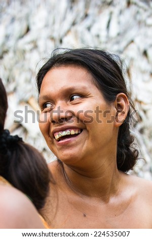 AMAZONIA, PERU - NOV 10, 2010: Unidentified Amazonian indigenous smiling woman. Indigenous people of Amazonia are protected by COICA (Coordinator of Indigenous Organizations of the Amazon River Basin)
