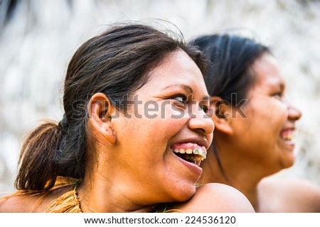 AMAZONIA, PERU - NOV 10, 2010: Unidentified Amazonian indigenous two women laugh.Indigenous people of Amazonia are protected byCOICA (Coordinator of Indigenous Organizations of the Amazon River Basin)
