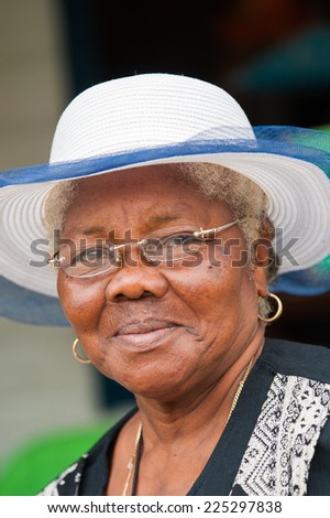 GUATEMALA CITY, GUATEMALA - JANUARY 3, 2012: Portrait of unidentified smiling old lady in a white hat in Guatemala. 59.4% of Guatemala people belong to the Mestizo ethnic group