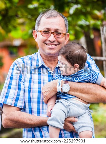 GUATEMALA CITY, GUATEMALA - JANUARY 1, 2012: Portrait of unidentified man holding his baby in Guatemala. 59.4% of Guatemala people belong to the Mestizo ethnic group