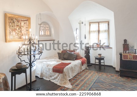 BRAN, ROMANIA - OCTOBER 27, 2013:  One of the bedrooms of the Dracula Castle in Bran, Romania, on October 27, 2013.It is marketed as the home of the Vampire Dracula, the Bram Stoker\'s novel character.
