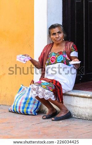 MEXICO CITY, MEXICO - DEC 29, 2011: Unidentified Mexican woman sells napkins and wears traditional falk clothes. 60% of Mexican people belong to the Mestizo ethnic group