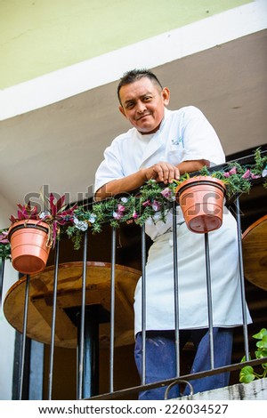 MEXICO CITY, MEXICO - DEC 29, 2011: Unidentified Mexican man smiles on the balcony. 60% of Mexican people belong to the Mestizo ethnic group