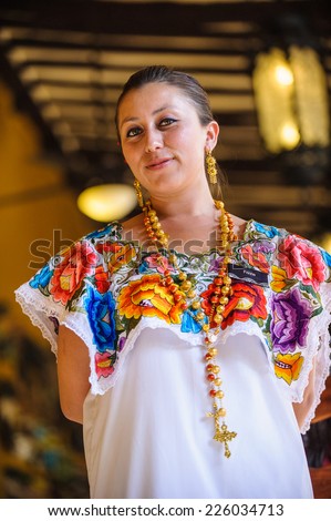 MEXICO CITY, MEXICO - DEC 29, 2011: Unidentified Mexican woman in beautiful traditional drawing clothes.  60% of Mexican people belong to the Mestizo ethnic group