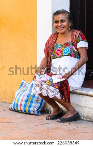 MEXICO CITY, MEXICO - DEC 29, 2011: Unidentified Mexican woman sells napkins and wears traditional falk clothes. 60% of Mexican people belong to the Mestizo ethnic group