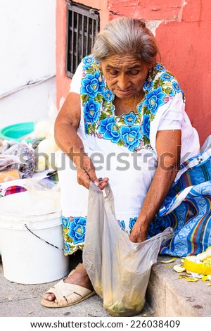 MEXICO CITY, MEXICO - DEC 29, 2011: Unidentified Mexican woman checks out her bag.  60% of Mexican people belong to the Mestizo ethnic group