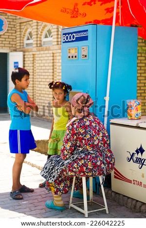KHIVA, UZBEKISTAN - JUNE 4, 2011: Two unidentified Uzbek children want to buy gas water in Uzbekistan, Jun 4, 2011.  81% of people in Uzbekistan belong to Uzbek ethnic group