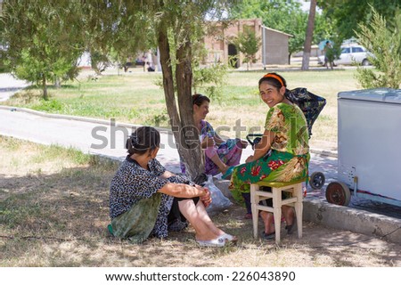 BUKHARA, UZBEKISTAN - JUNE 8, 2011: Unidentified Uzbek women speak under the tree in Uzbekistan, Jun 8, 2011.  81% of people in Uzbekistan belong to Uzbek ethnic group