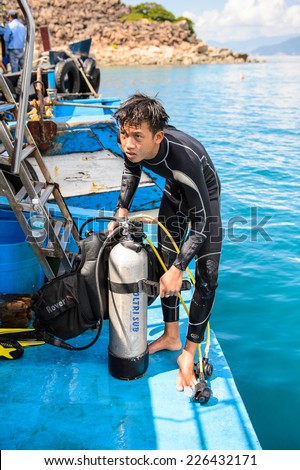 NHA TRANG, VIETNAM - SEP 30, 2014: Unidentified man on the boat in the South China Sea. South China Sea is 3,500,000 square kilometres