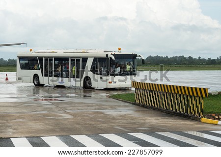SIEM REAP, CAMBODIA - SEP 29, 2014: Bus with passenger at the Siemreap International Airport. It is the busiest airport in Cambodia in terms of passenger traffic.