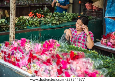 HANOI, VIETNAM - SEP 23. 2014: Unidentified Vietnamese people work at the flower market in Hanoi, Vietnam. Flower market in Hanoi is one of the largest flower markets in Vietnam