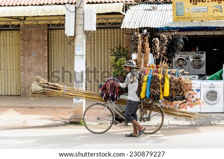 SIEM RIEP, CAMBODIA - SEP 28, 2014: Unidentified Khmer man carries stuff to sell in Siem Reap. 90% of Cambodian people belong to Khmer etnic group