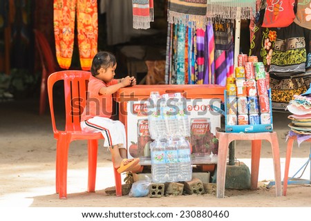 SIEMREAP, CAMBODIA - SEP 27, 2014: Unidentified Khmer girl on a market at the Angkor Thom. 90% of Cambodian people belong to Khmer etnic group