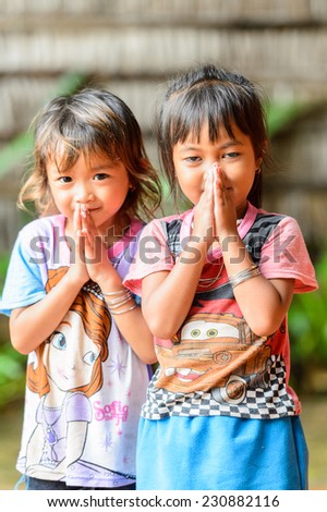 SIEM RIEP, CAMBODIA - SEP 28, 2014: Unidentified Khmer little girls say hello to the camera in Siem Reap. 90% of Cambodian people belong to Khmer etnic group