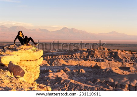 ATACAMA DESERT, CHILE - NOV 3, 2014: Unidentified tourist poses in the Atacama desert, Chile. Atacama Desert proper occupies 105,000 square kilometres