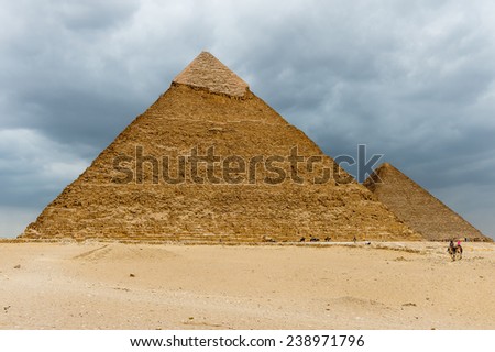 GIZA, EGYPT - NOV 23, 2014: Unidentified Egyptian man rides a camel in Giza Necropolis, Egypt. UNESCO World Heritage