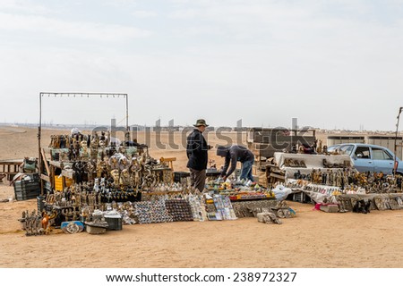 GIZA, EGYPT - NOV 23, 2014: Unidentified Egyptian people sell souvenirs in Giza Necropolis, Egypt. UNESCO World Heritage