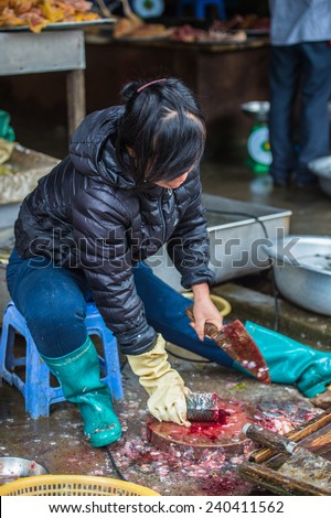 SAPA, VIETNAM - SEP 20, 2014: Unidentified Hmong woman in a traditional costume work on a market. Hmong people is a minority ethnic group living in Sapa