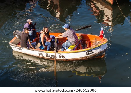 VALPARAISO, CHILE - NOV 9, 2014: Unidentified people on a boat at the Port of Valparaiso. Valparaiso is an important port city on the Pacific Coast of Chile.