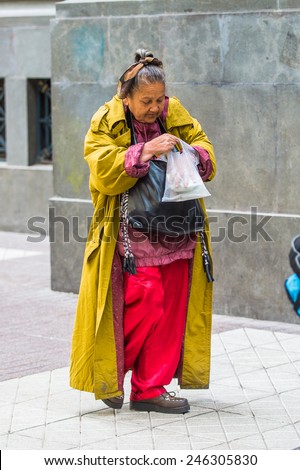 SANTIAGO, CHILE - NOV 1, 2014:  Unidentified Chilean poor woman in the street in Santiago. Chilean people are mainly of mixed Spanish and Amerindian descent