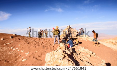 ATACAMA DESERT, CHILE - NOV 3, 2014: Unidentified tourists in the Atacama desert, Chile. Atacama Desert proper occupies 105,000 square kilometres