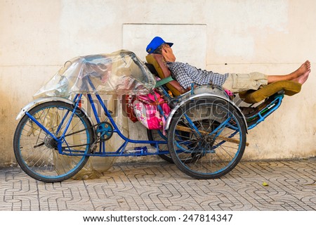 HO CHI MINH, VIETNAM - SEP 20, 2014: Unidentified Vietnamese man sleeps over his motorbike. 90% of Vietnamese people belong to the Viet ethnic group