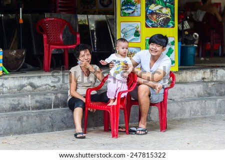 HO CHI MINH, VIETNAM - SEP 20, 2014: Unidentified Vietnamese family with a little baby on the chair. 90% of Vietnamese people belong to the Viet ethnic group