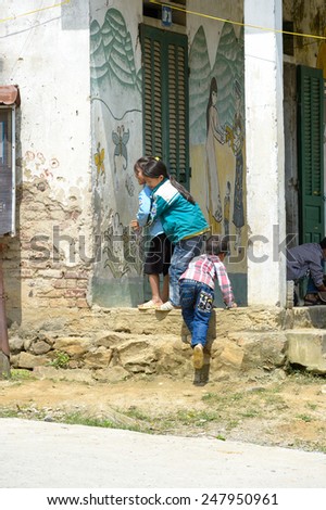 LAO CHAI VILLAGE, VIETNAM - SEP 22, 2014: Unidentified Hmong children play outside in Lao Chai. Hmong is on of the minority eethnic group in Vietnam