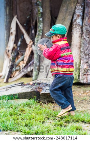 TA PHIN, LAO CAI, VIETNAM - SEP 21, 2014:  Unidentified Red Dao boy plays outside. Red Dao is one of the minority ethnic groups in Vietnam