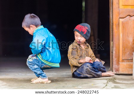 TA PHIN, LAO CAI, VIETNAM - SEP 21, 2014:  Unidentified Red Dao boy plays outside. Red Dao is one of the minority ethnic groups in Vietnam