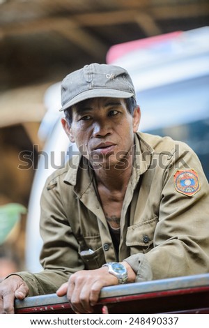LUANG PRABANG, LAOS - SEP 25, 2014: Unidentified Lao man in a military form. 55% of Laos people belong to the Lao ethnic group