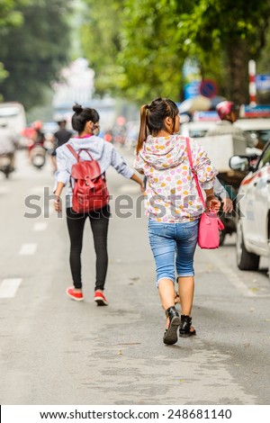 HANOI, VIETNAM - SEP 23, 2014: Unidentified Vietnamese women in the street. 92% of Vietnamese people belong to the Viet ethnic group