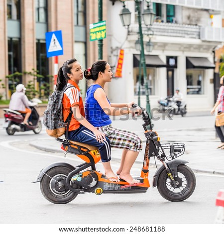 HANOI, VIETNAM - SEP 23, 2014: Unidentified Vietnamese women on motorbike. 92% of Vietnamese people belong to the Viet ethnic group