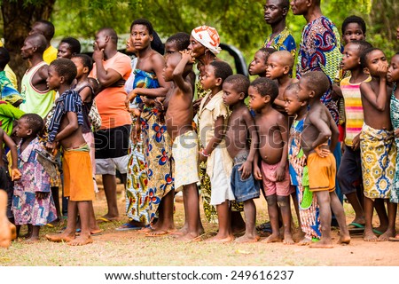 KARA, TOGO - MAR 9, 2013: Unidentified Togolese children watch and dance at the local music show. Children in Togo suffer of poverty due to the unstable econimic situation