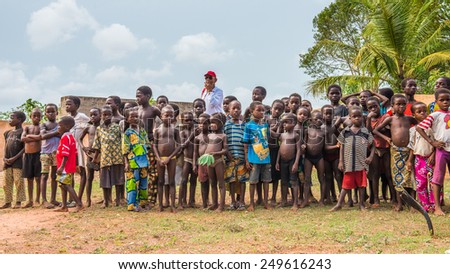 KARA, TOGO - MAR 9, 2013: Unidentified Togolese children watch the local music show. People in Togo suffer of poverty due to the unstable econimic situation