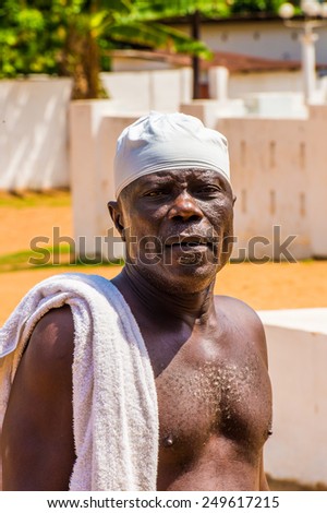 KARA, TOGO - MAR 9, 2013: Unidentified Togolese serious man with a towel on his shoulder. People in Togo suffer of poverty due to the unstable econimic situation