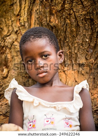 KARA, TOGO - MAR 9, 2013: Unidentified Togolese beautiful little girl close up portrait. Children in Togo suffer of poverty due to the unstable econimic situation