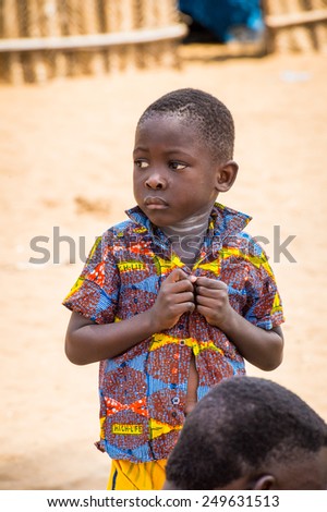 KARA, TOGO - MAR 9, 2013: Unidentified Togolese boy wears a shirt with buttons. People in Togo suffer of poverty due to the unstable econimic situation