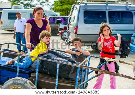 SAN JOSE, COSTA RICA - JAN 6, 2012: Unidentified Costa Rican children in a carriage with luggage. 65.8% of Costa Rican people belong to the White (Castizo) ethnic group