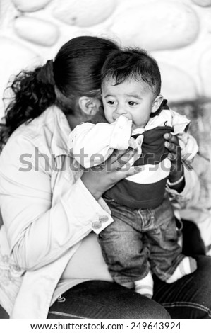 SAN JOSE, COSTA RICA - JAN 6, 2012: Unidentified Costa Rican mother and her baby. 65.8% of Costa Rican people belong to the White (Castizo) ethnic group