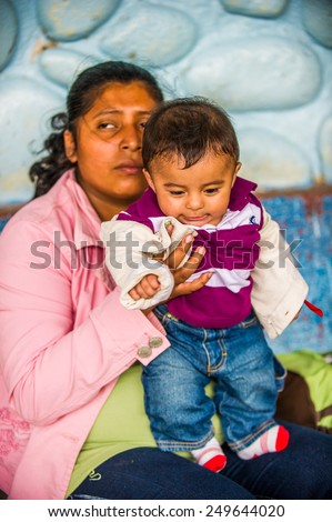 SAN JOSE, COSTA RICA - JAN 6, 2012: Unidentified Costa Rican mother and her baby. 65.8% of Costa Rican people belong to the White (Castizo) ethnic group
