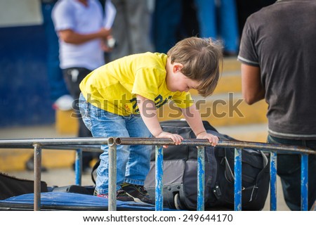 SAN JOSE, COSTA RICA - JAN 6, 2012: Unidentified Costa Rican children in a carriage with luggage. 65.8% of Costa Rican people belong to the White (Castizo) ethnic group