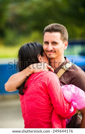 SAN JOSE, COSTA RICA - JAN 6, 2012: Unidentified Costa Rican girl hugs her boyfriend. 65.8% of Costa Rican people belong to the White (Castizo) ethnic group