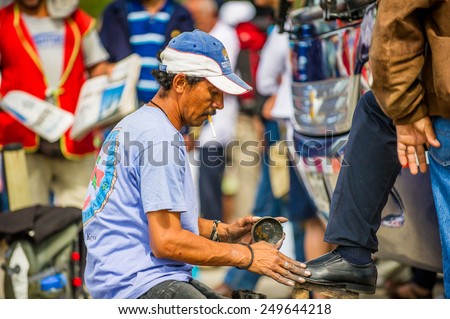 SAN JOSE, COSTA RICA - JAN 6, 2012: Unidentified Costa Rican man cleans shoes to the other man. 65.8% of Costa Rican people belong to the White (Castizo) ethnic group