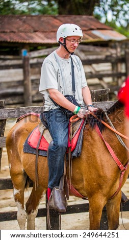 SAN JOSE, COSTA RICA - JAN 6, 2012: Unidentified Costa Rican man on a horse. 65.8% of Costa Rican people belong to the White (Castizo) ethnic group
