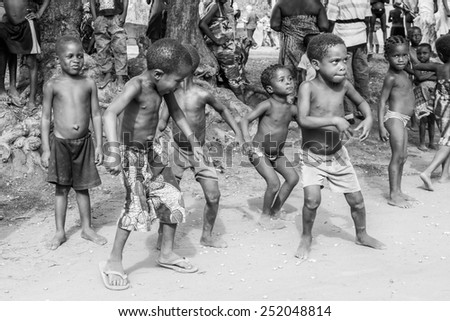 KARA, TOGO - MAR 9, 2013: Unidentified Togolese children dance and play during a local dance show. People in Togo suffer of poverty due to the unstable econimic situation